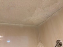 Ceiling over shower looks ready to fall on you