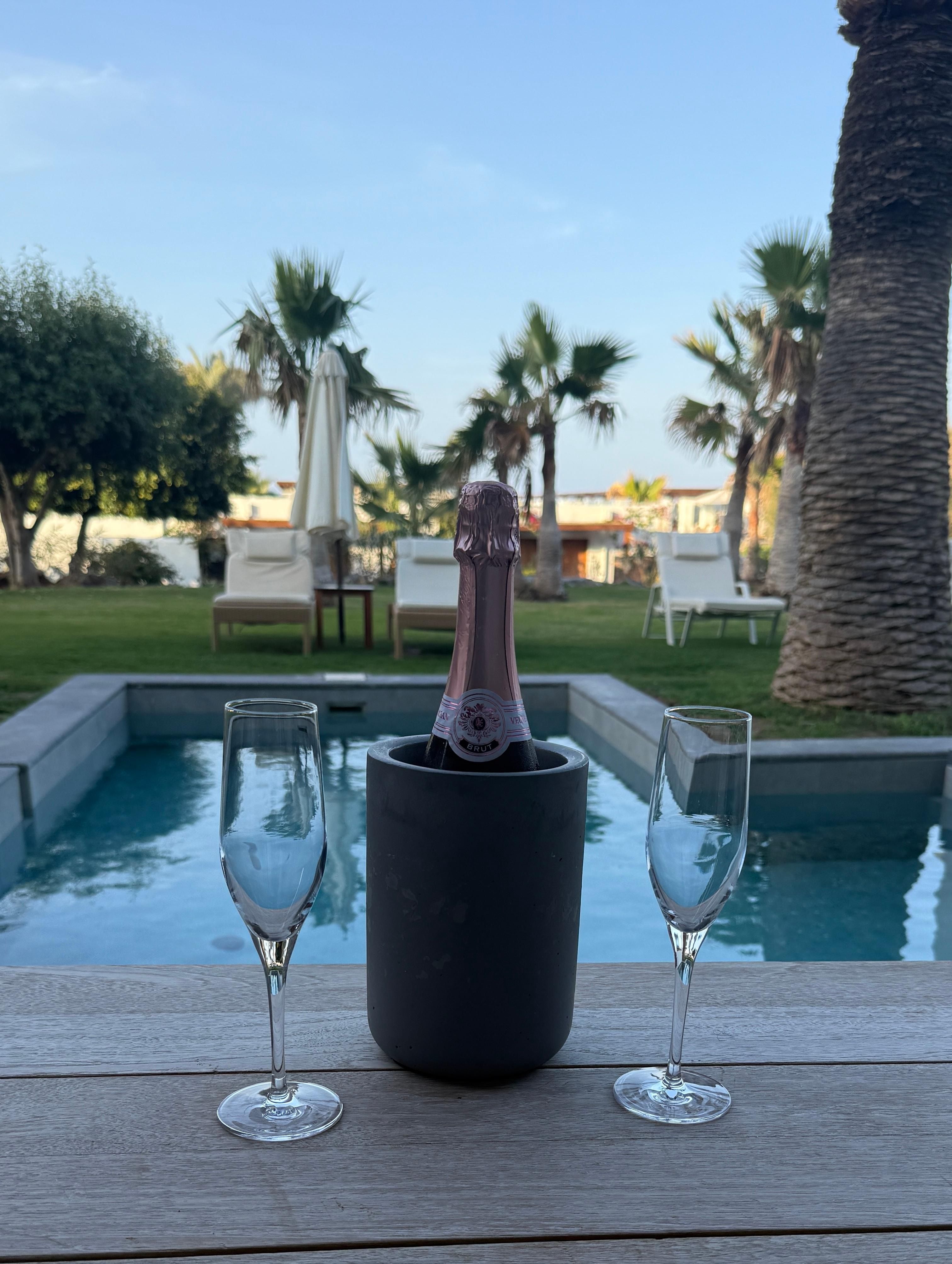 Bottle of champagne and goodies by our own private pool.