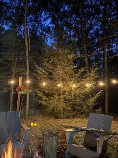 Wonderful deck and below is a firepit surrounded by lights and mums