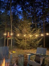 Wonderful deck and below is a firepit surrounded by lights and mums
