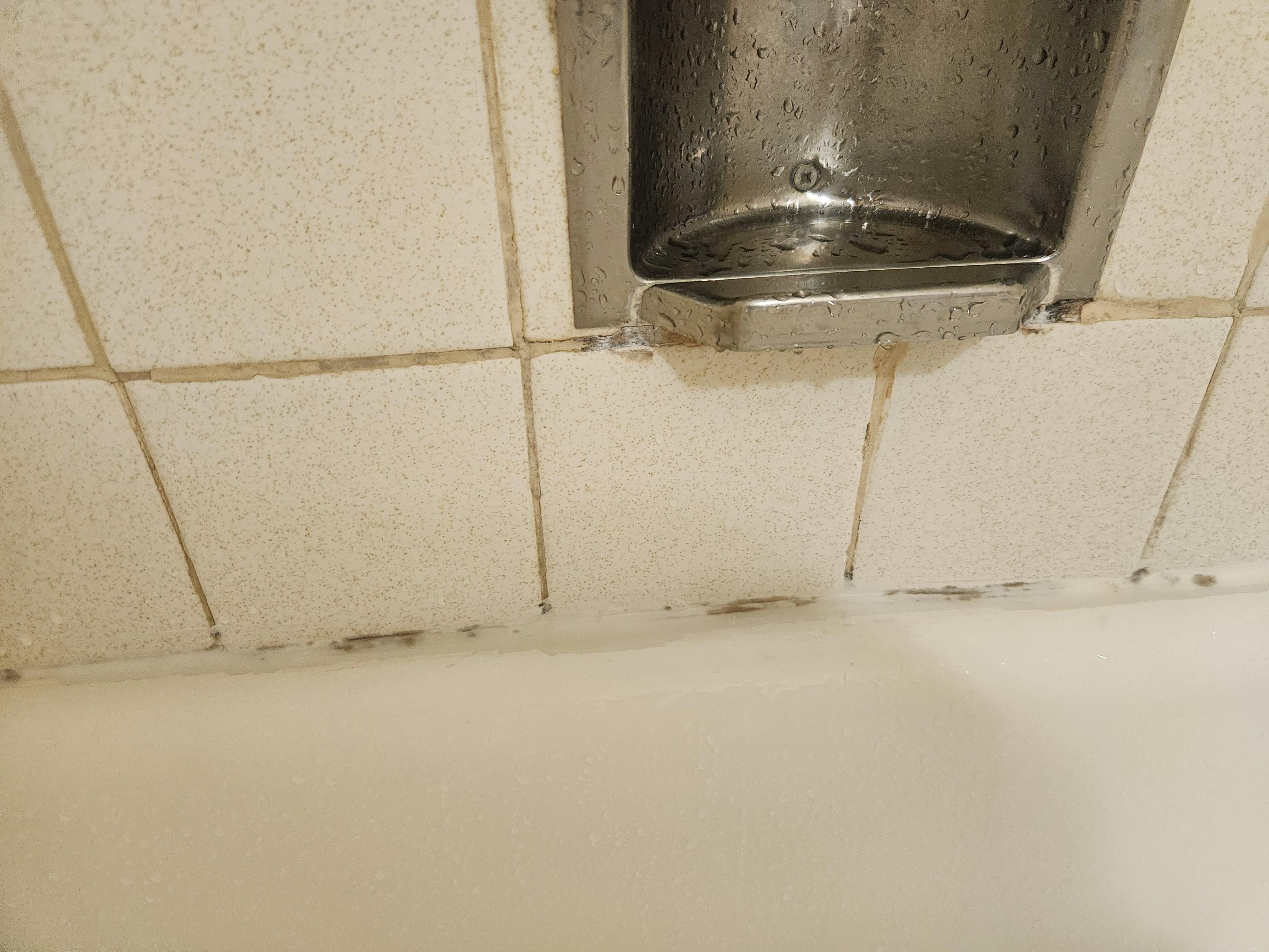 Bathtub caulking needs replacing.
