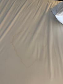 Dried urine in my bed hidden by sheets
