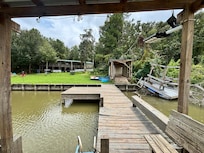 a dock washed up and left in a junk pile next to the boat storage shed