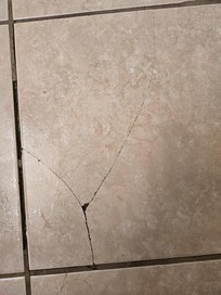 Broken tiles on bathroom floor