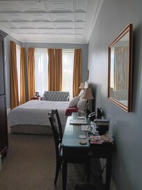 hotel room with desk and loveseat