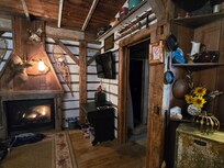 Dancing Fox Cabin - Fireplace and bathroom entrance.