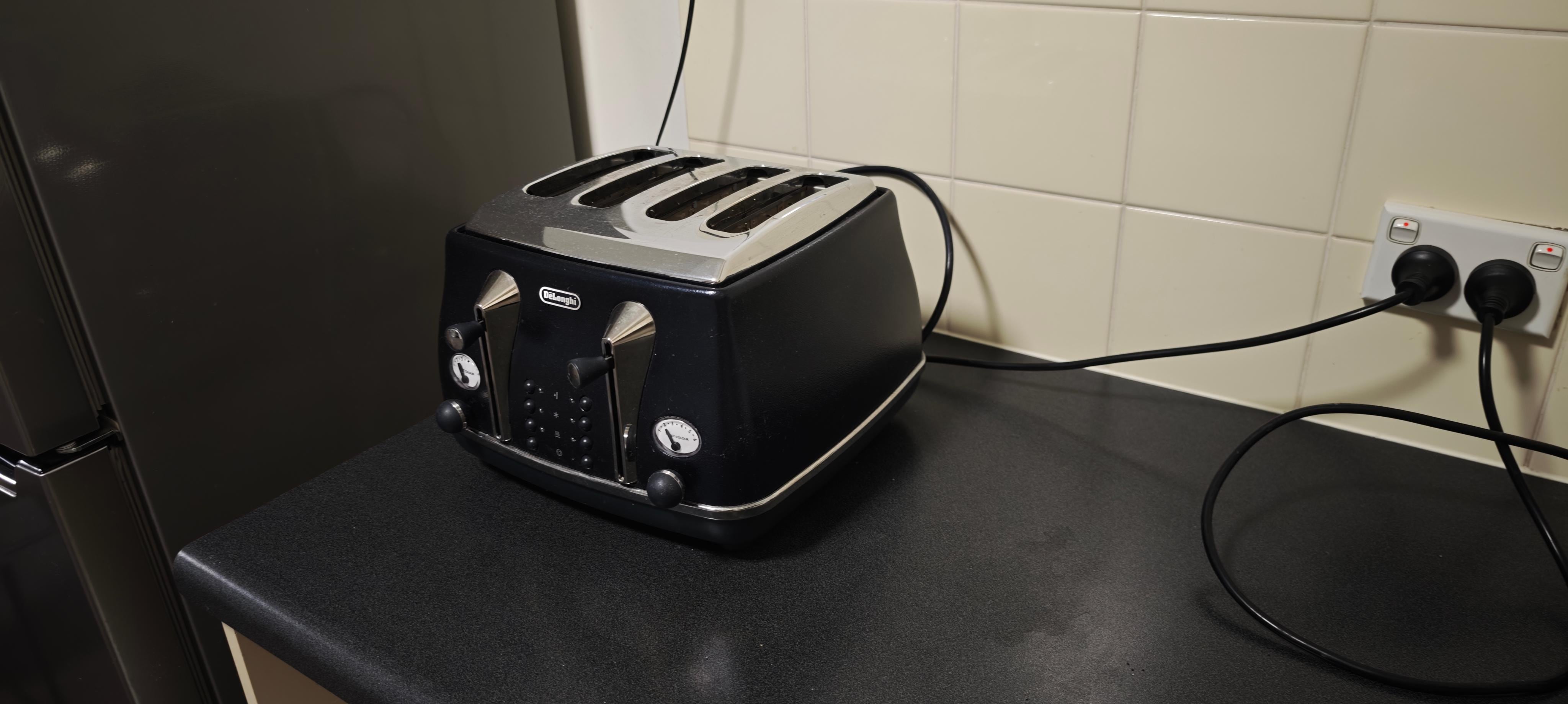 Fridge connected in outlet next to toaster, makes it easy to power down or unplug by mistake.