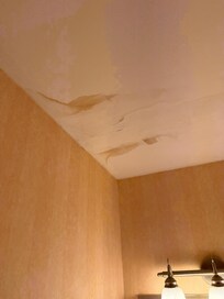 Peeling ceiling from a leak in the bathroom.