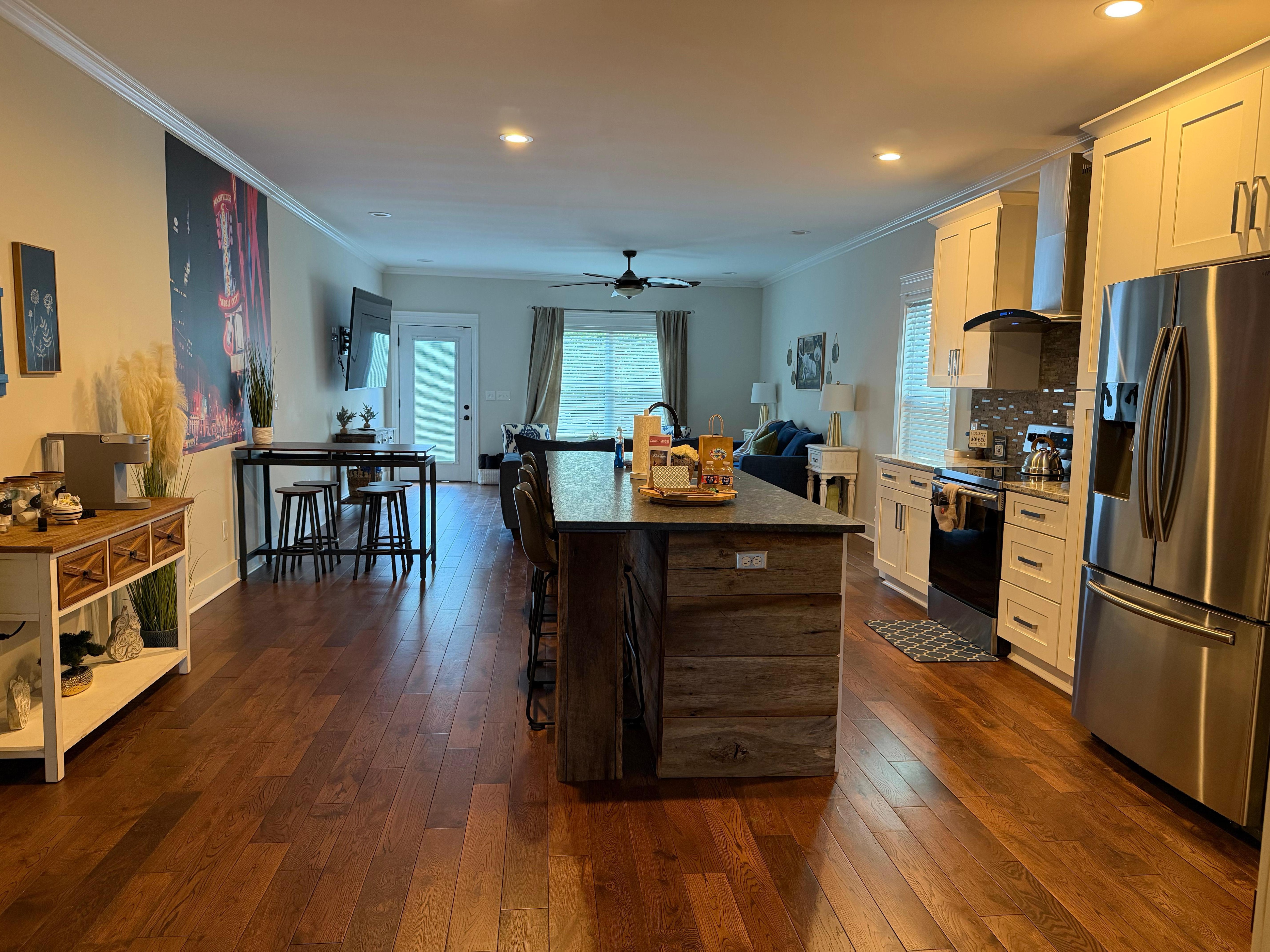 Gorgeous view of stocked kitchen and living. Huge dining table to the right