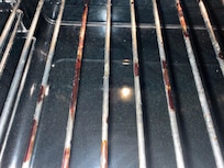 Burnt food left on the oven trays.