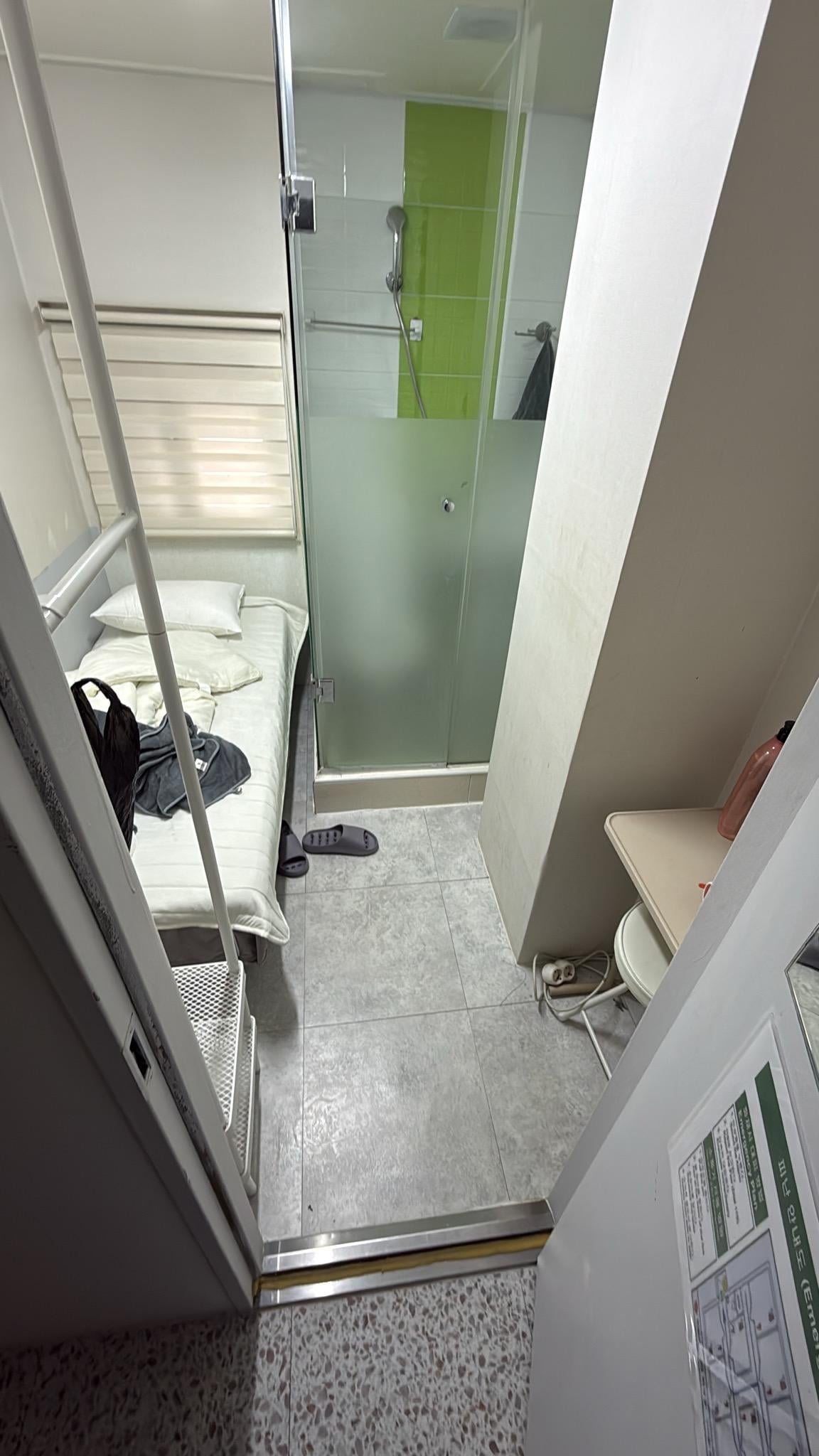 Unmade bed and left over trash and orange peels everywhere 