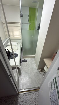 Unmade bed and left over trash and orange peels everywhere