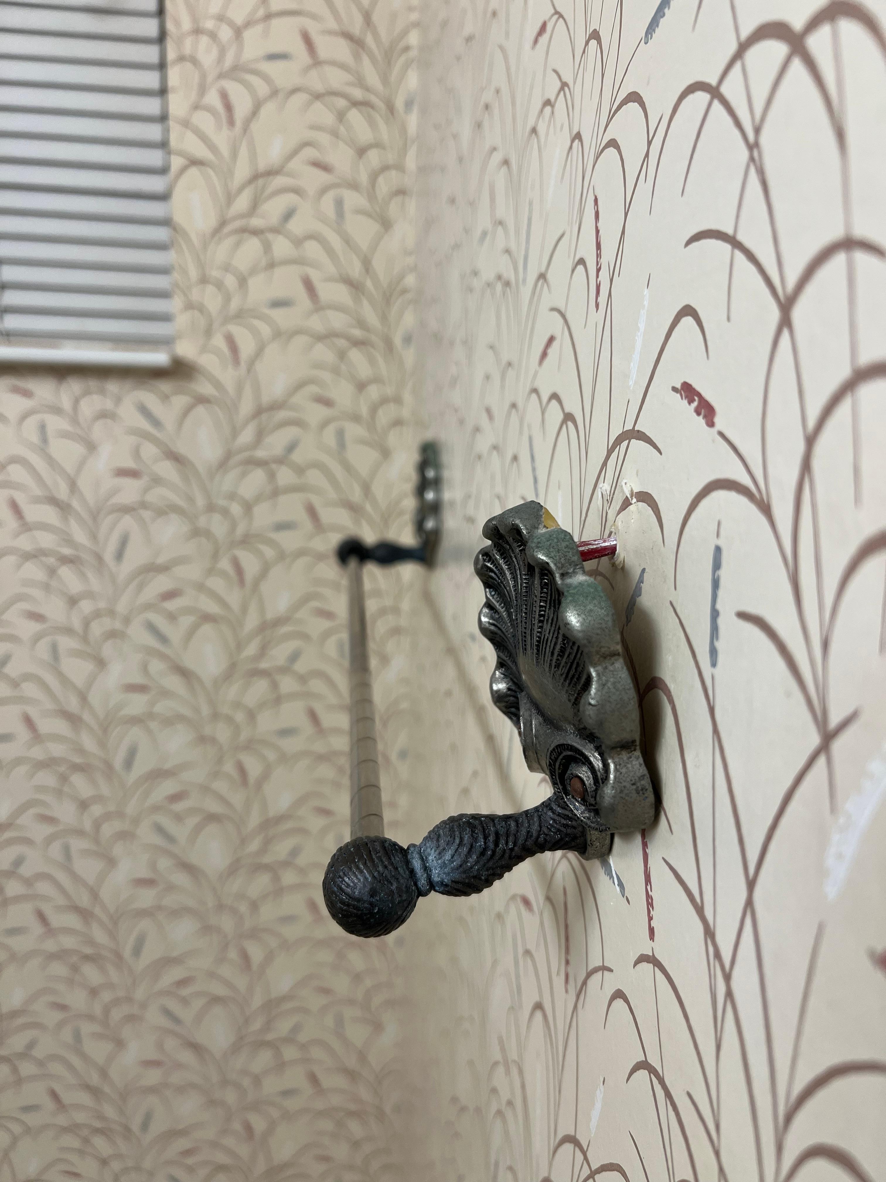 Towel rack hanging off the wall in master bath. 