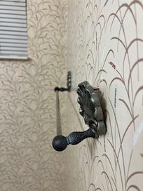 Towel rack hanging off the wall in master bath.