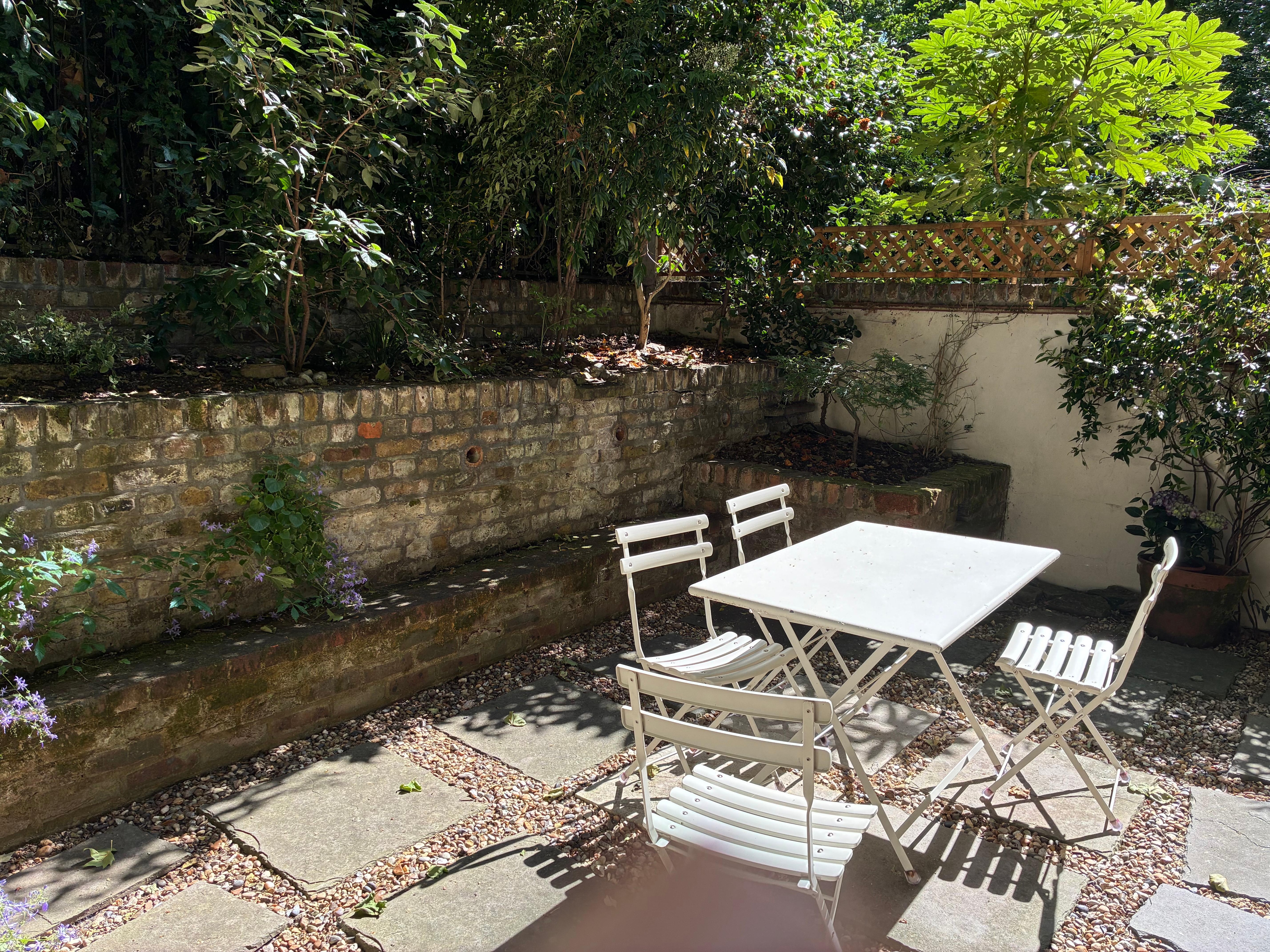 The seating in the flat’s garden. The Porchester Square park is over the fence from the flat