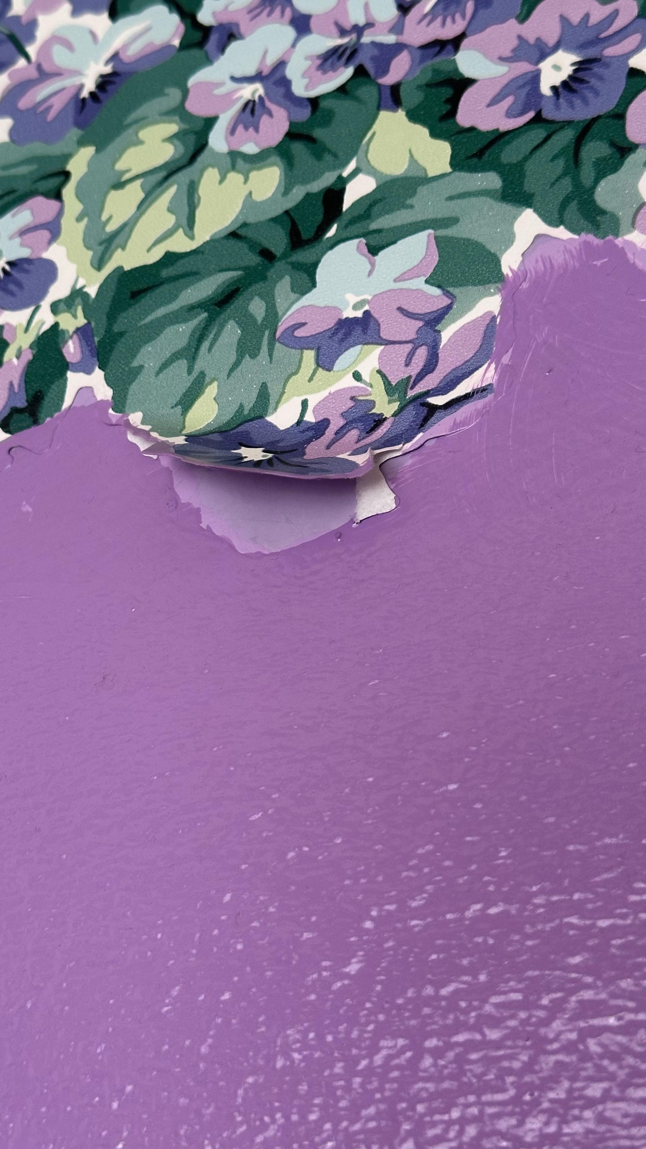 Peeling wallpaper and visible damage to the wall