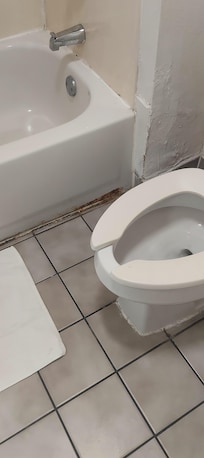 The tub is old and chipped poor caulking and horrible drywall work.