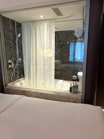 Glass window between bathroom and room before I put the blind down