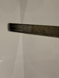 Plastic razor cover in bath overflow