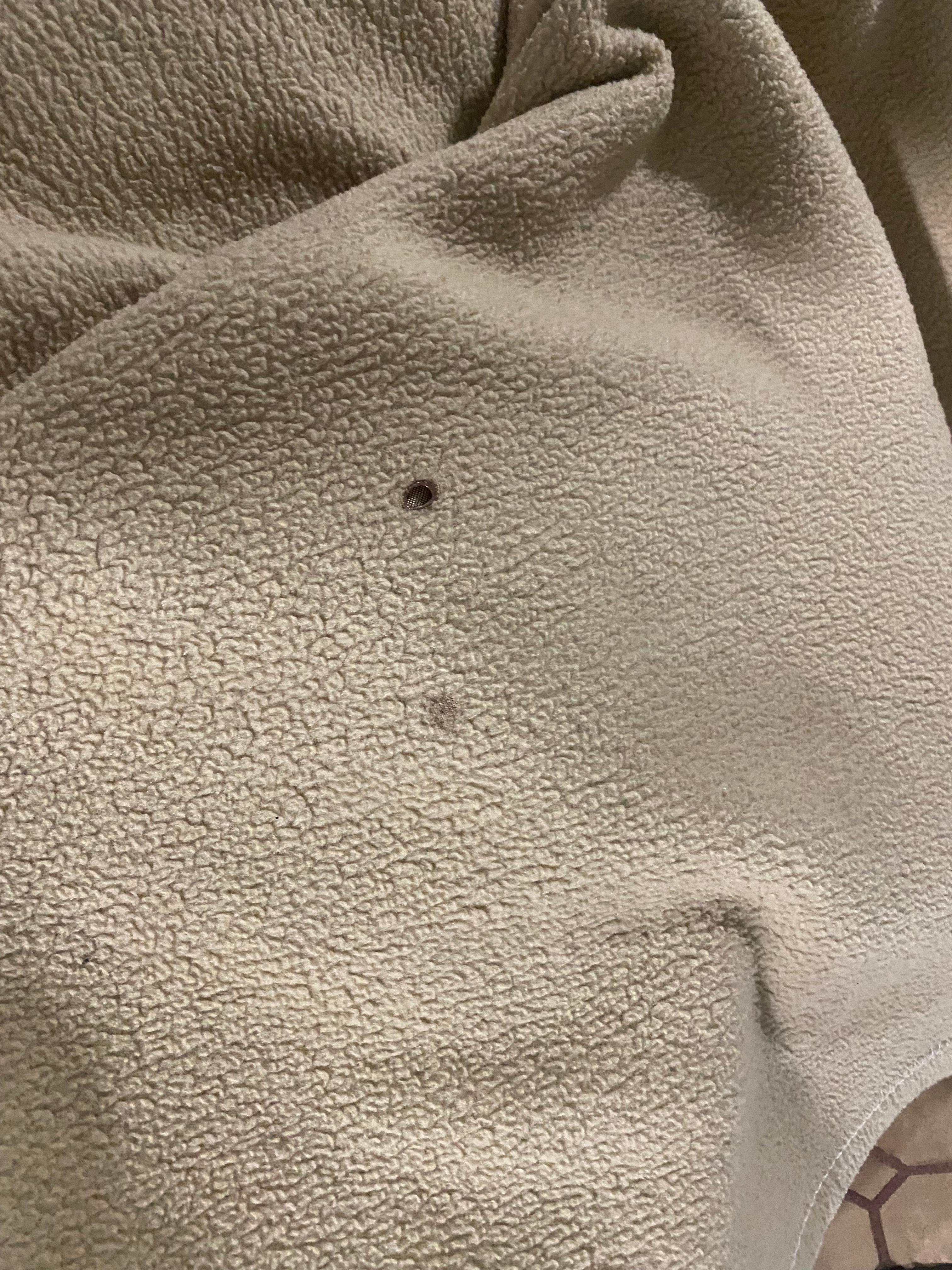 Cigarette burn holes in the blanket