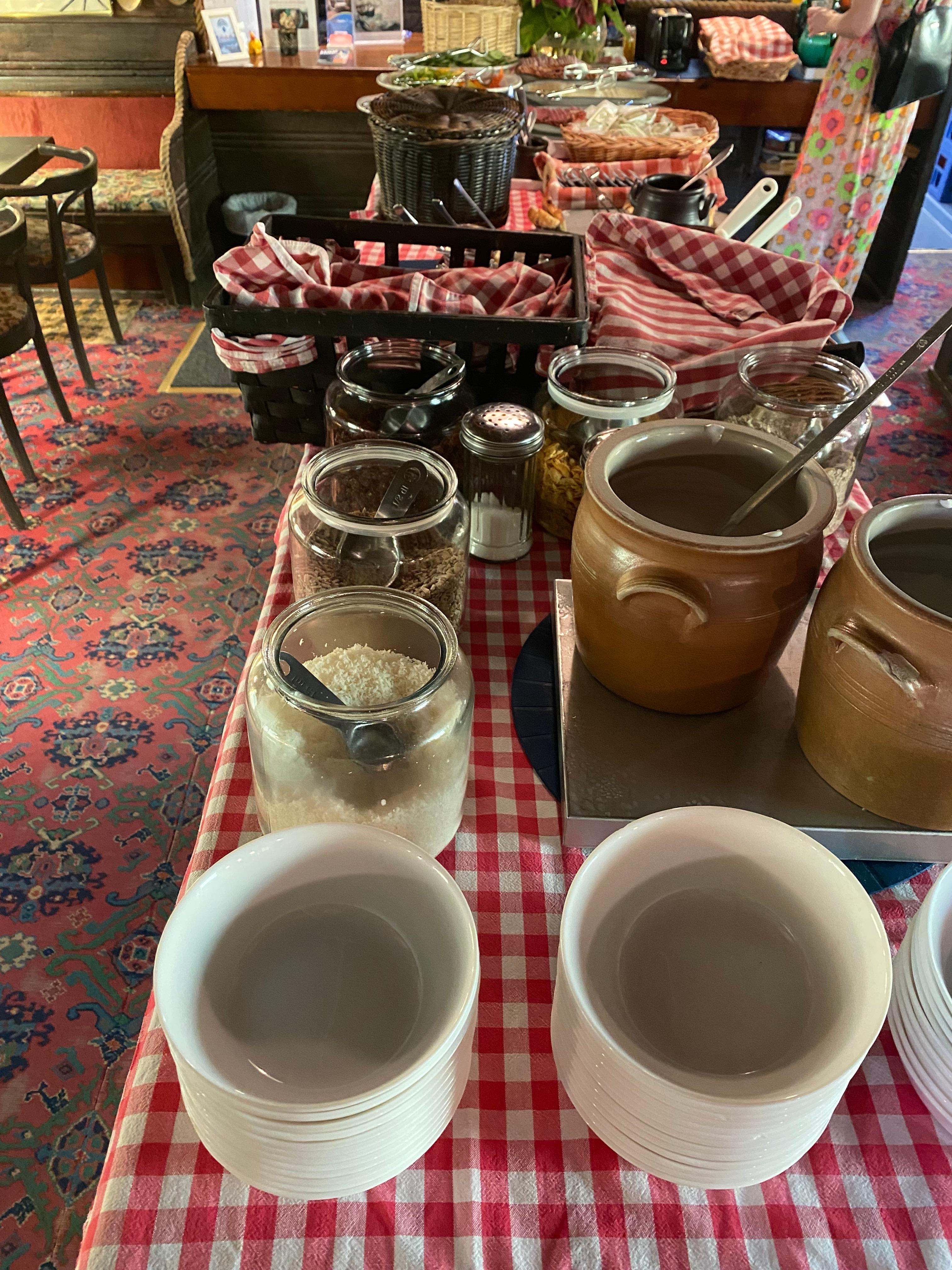 The main breakfast spread, with breads, butter and jams, soft-boiled eggs, cheese and sliced meat.