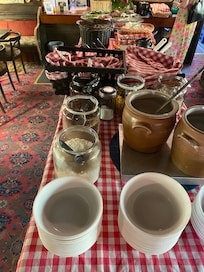 The main breakfast spread, with breads, butter and jams, soft-boiled eggs, cheese and sliced meat.