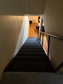 Stairs from second floor bedrooms going to kitchen/living room