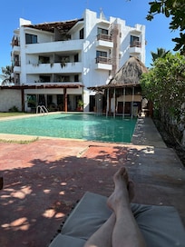 A view of hotel from the pool ... with very pale legs (to date).