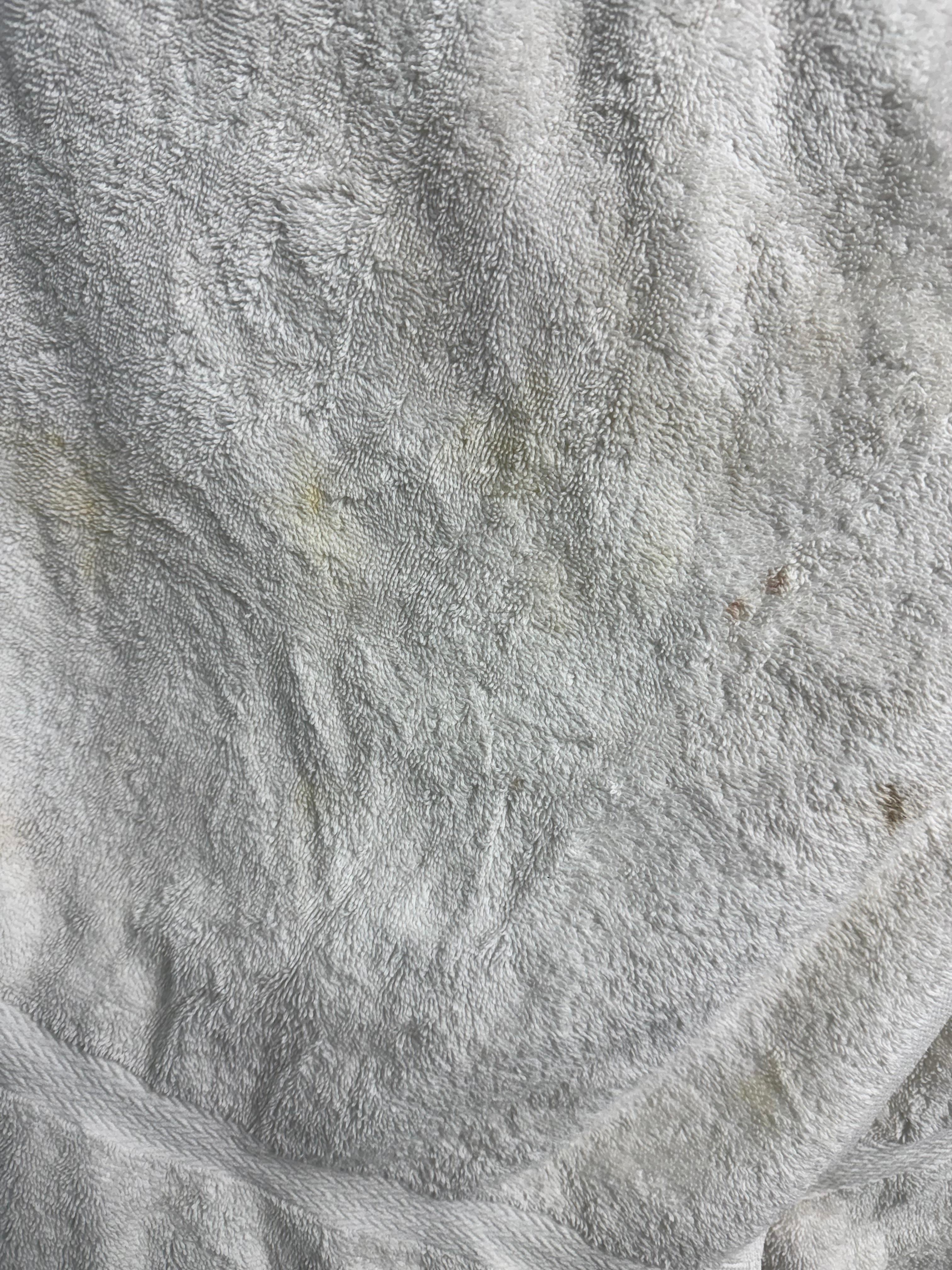 Yellow and black stains on a “fresh” towel