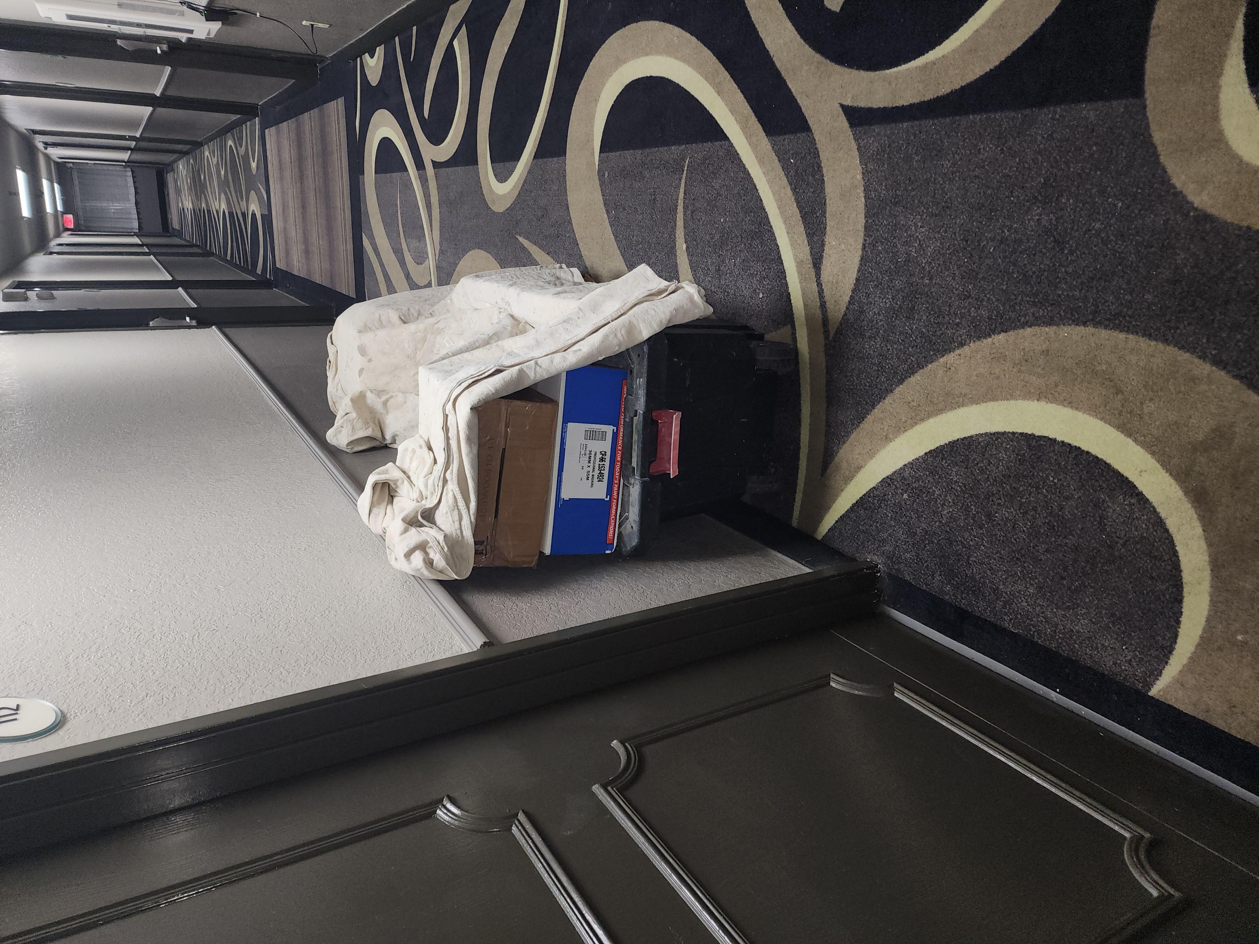 Paint thinners stored in hallway.