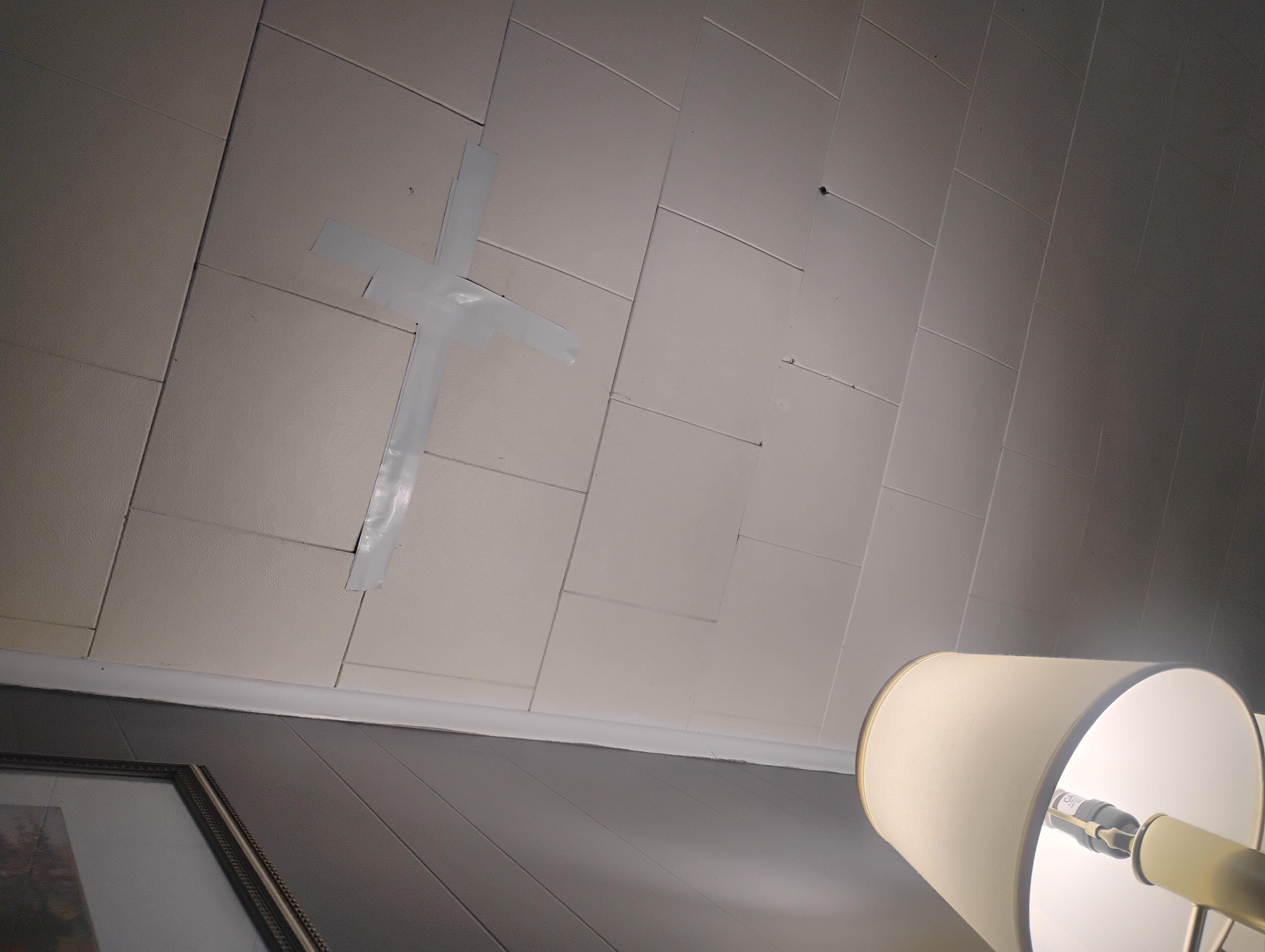 Tape on the ceiling above our bed