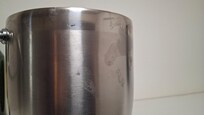 Uncleaned exterior of ice bucket that had oily finger prints from the previous guest.