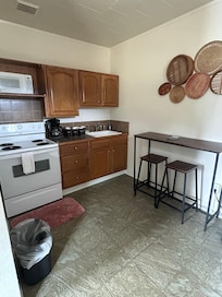 Full kitchen with dishes, pots, etc..