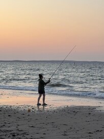 Grandson fishing, last light.