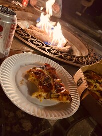 Seating area out front of hotel with gas fire.