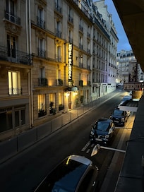 View up the street and around the corner is the entrance to the metro