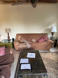 Torn couch house direction taped to coffee table with electrical tape.