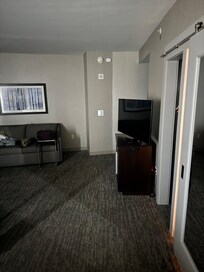 TV faces neither the bed or sitting area