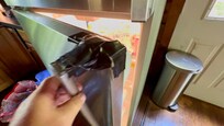 Duct tape on the handle of the refrigerator.