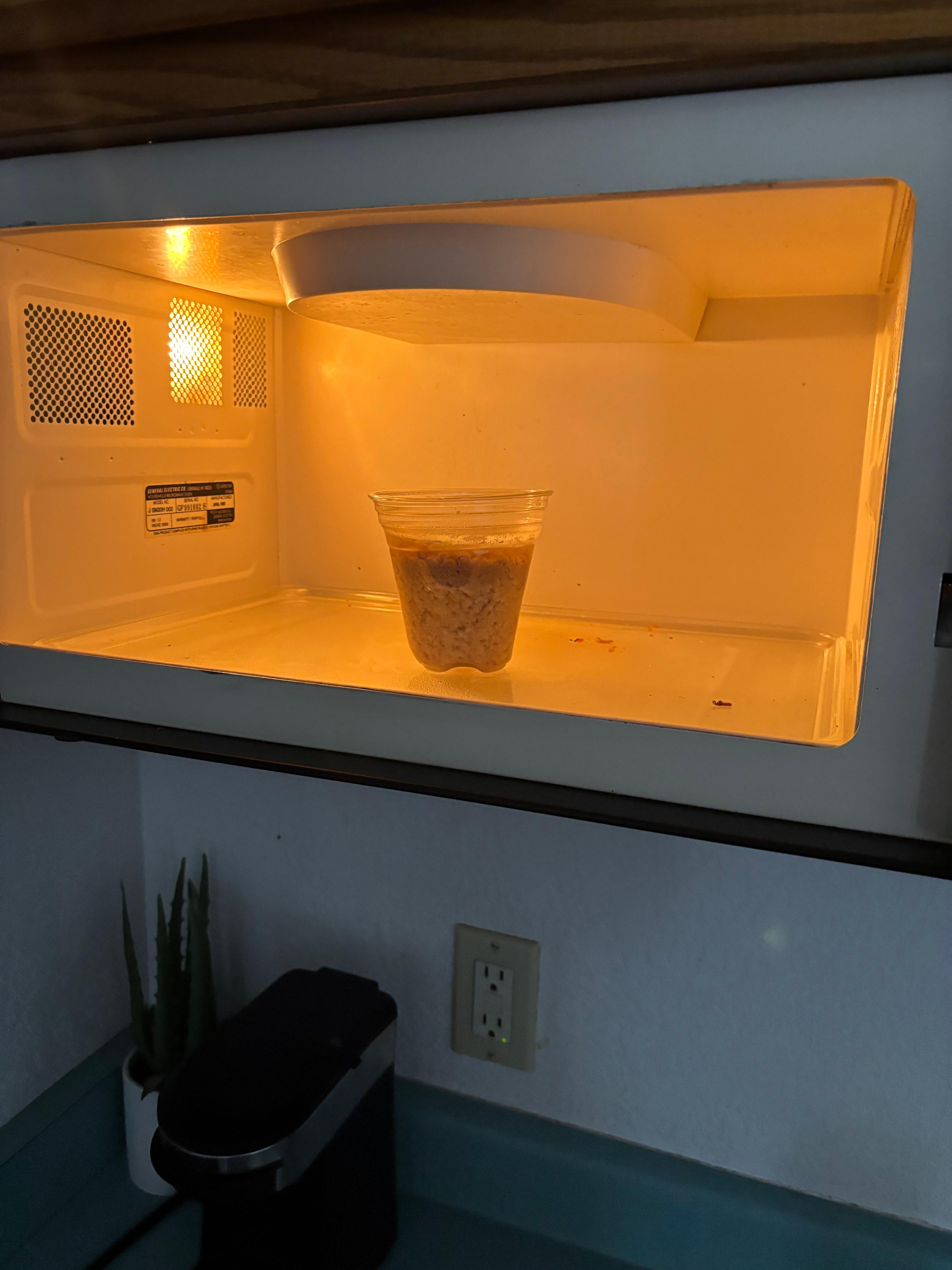 A plastic cup of coffee left in the microwave. The microwave was also gross on the inside.