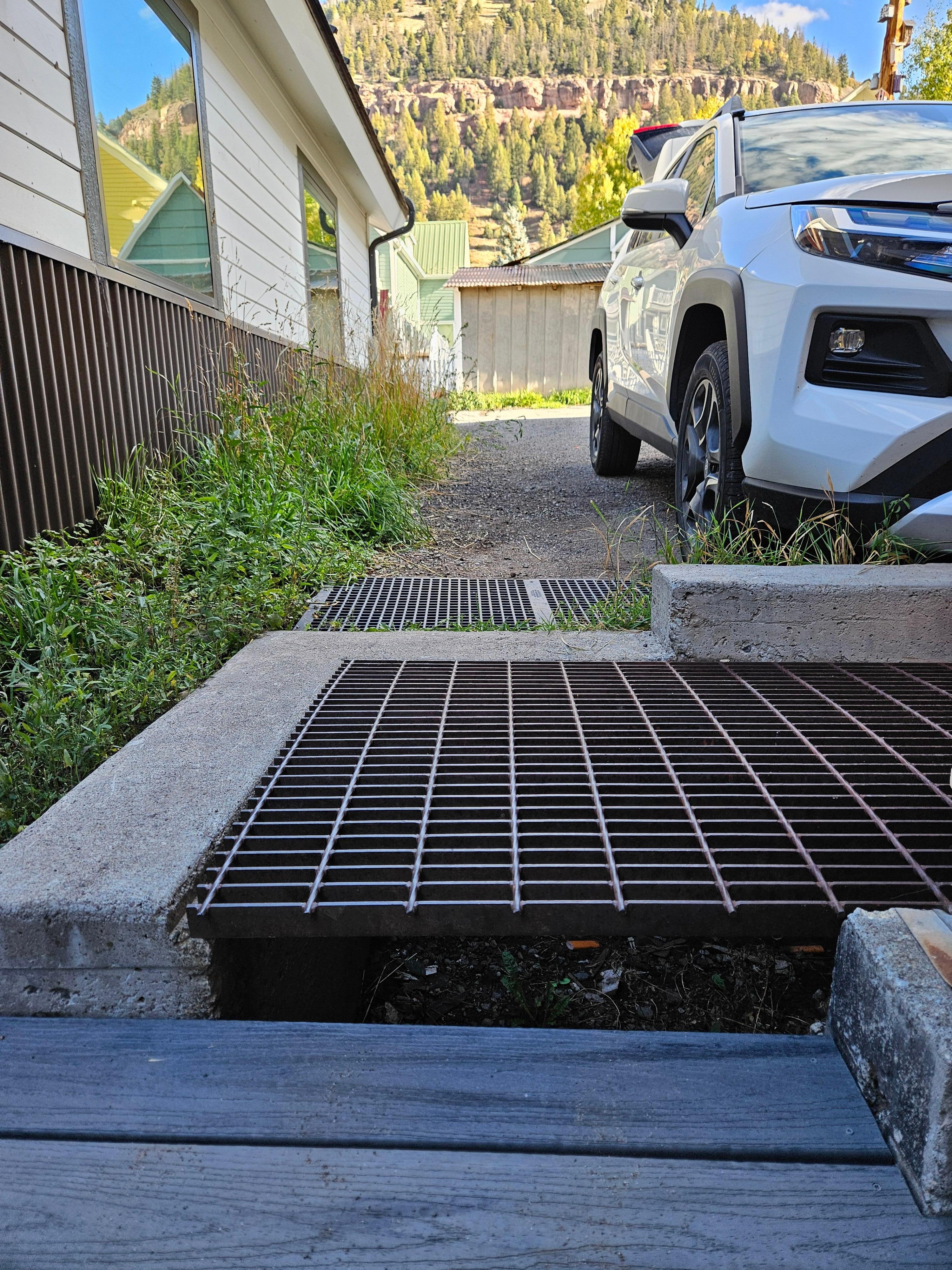 Nighttime hazard.  My foot went under the metal grate.  Needs better lighting.