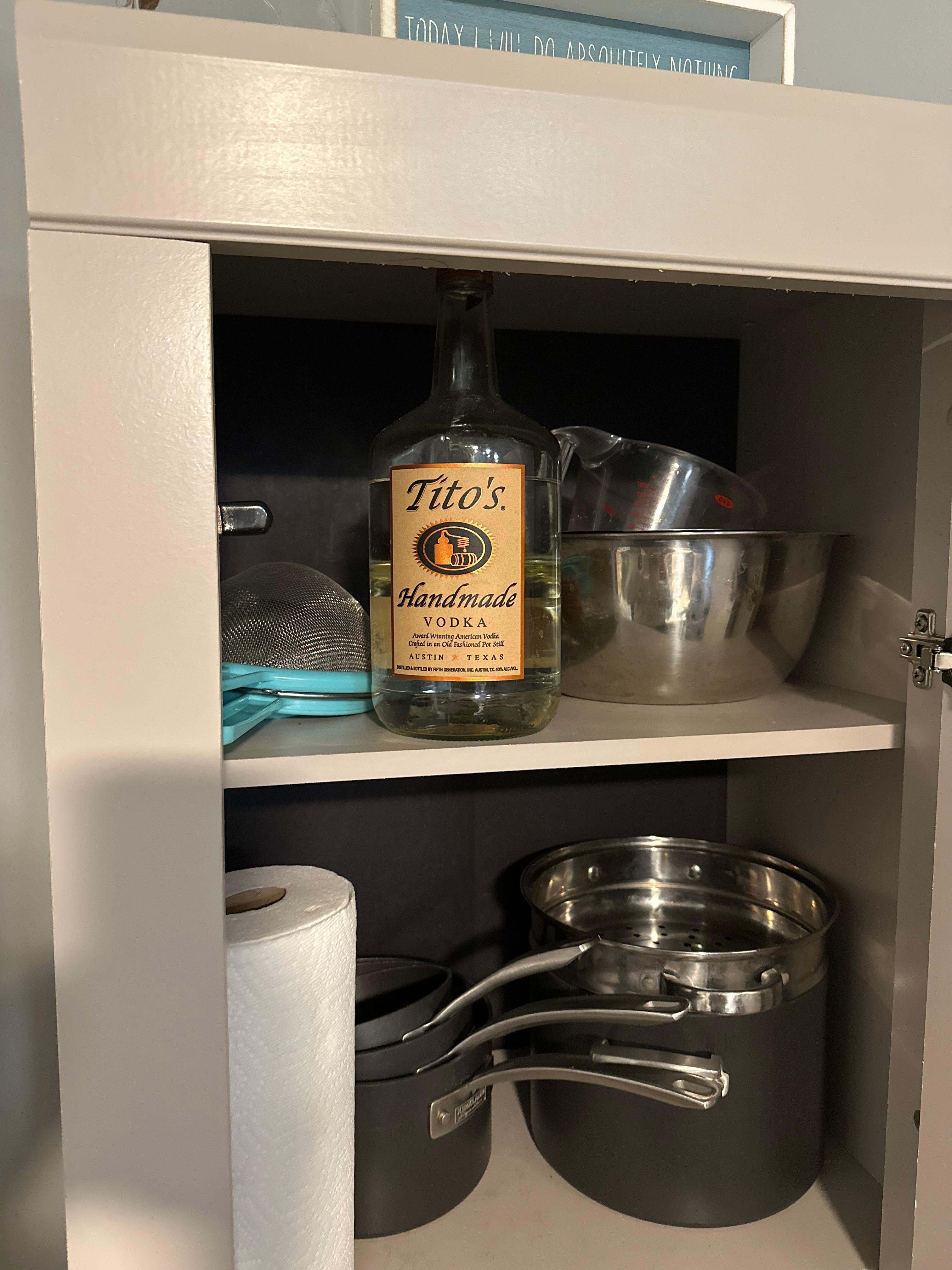 Random bottle of vodka in a kitchen cabinet