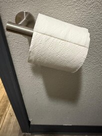 Toilet paper holder broken.