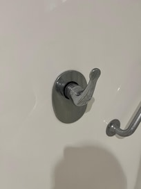 Bathroom shower handle turns 360 degrees and was difficult to use.