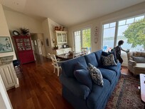 Living room looking at dining room with kitchen on the left, and door out to the back patio