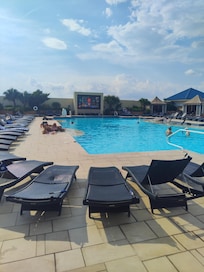 Great rooftop pool with a large screen.