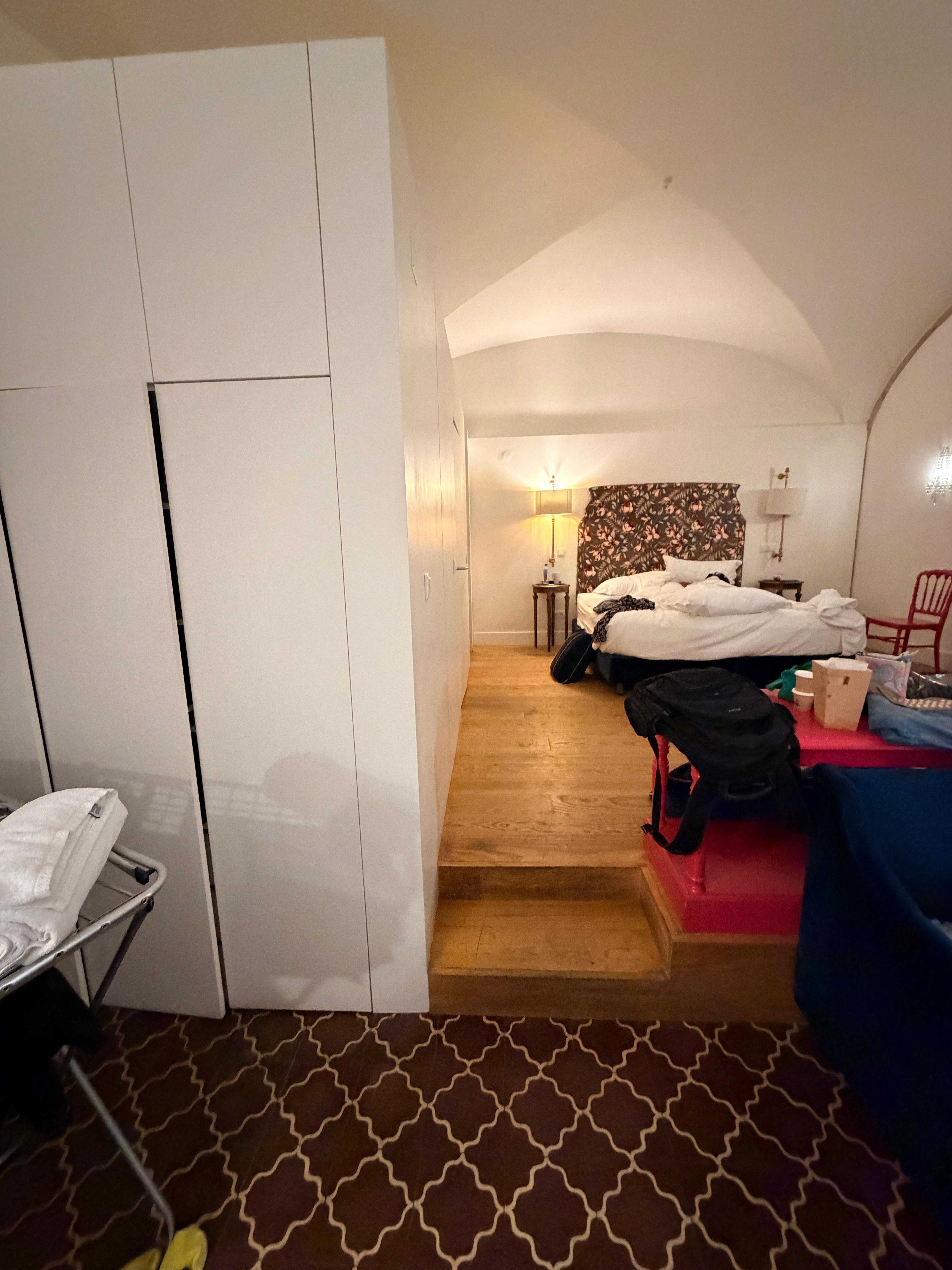 See the step and the closet. The closet is the bathroom with broken door and no water. The step is where all plumbing is probably is to make this store function as a room and which failed