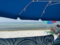 Beach right outside the condo while under the rental umbrella and chairs