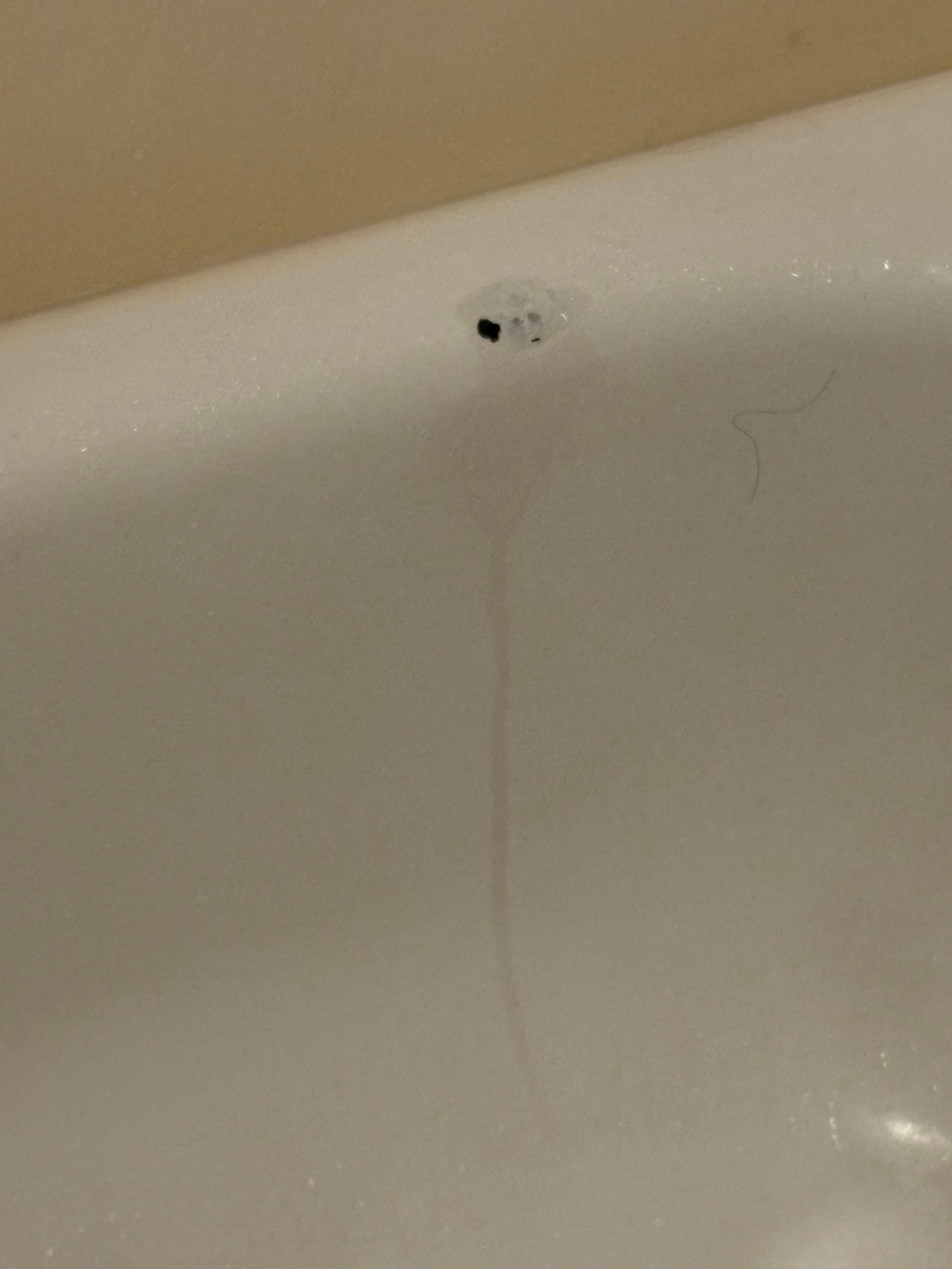 Burnt hole in tub. 