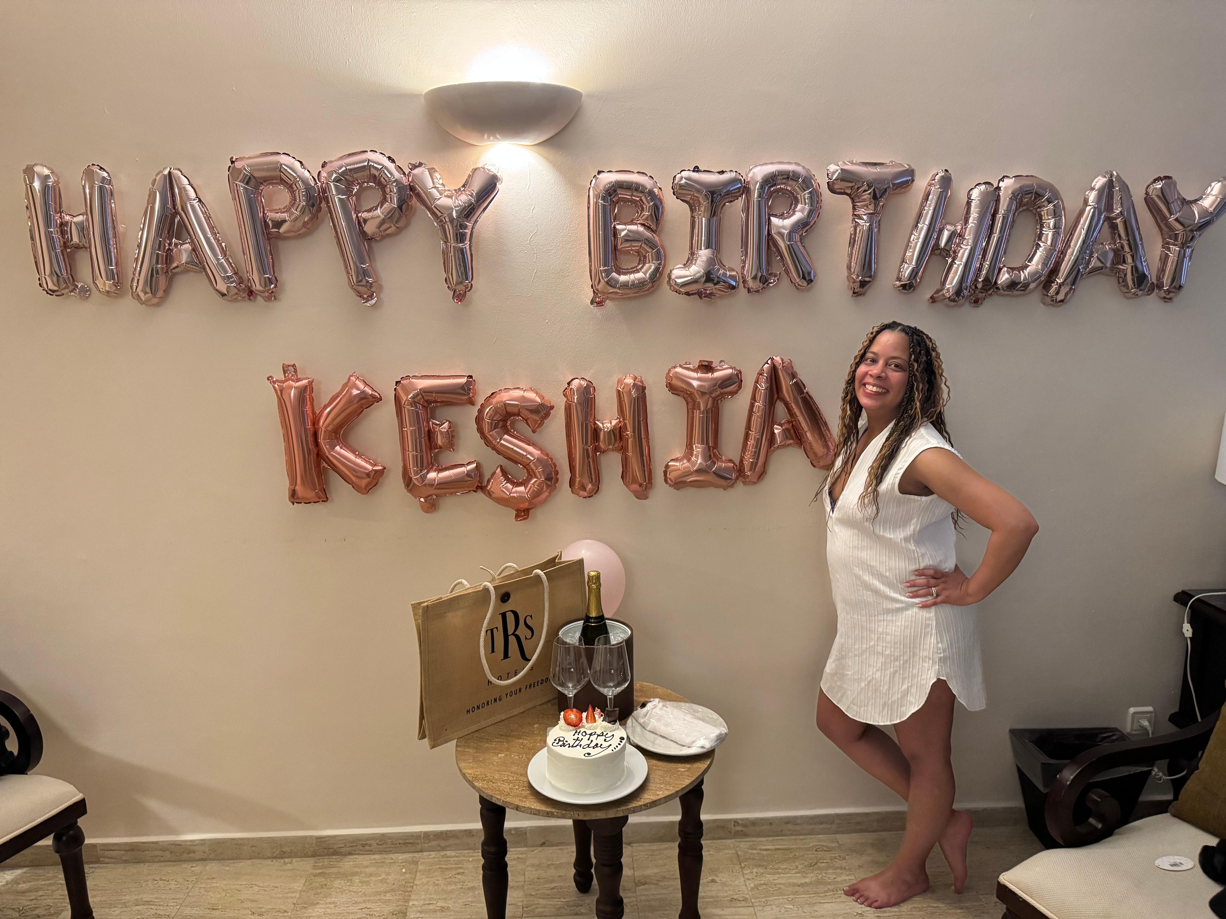 Some Birthday decorations, cake, bottle set by the staff. 